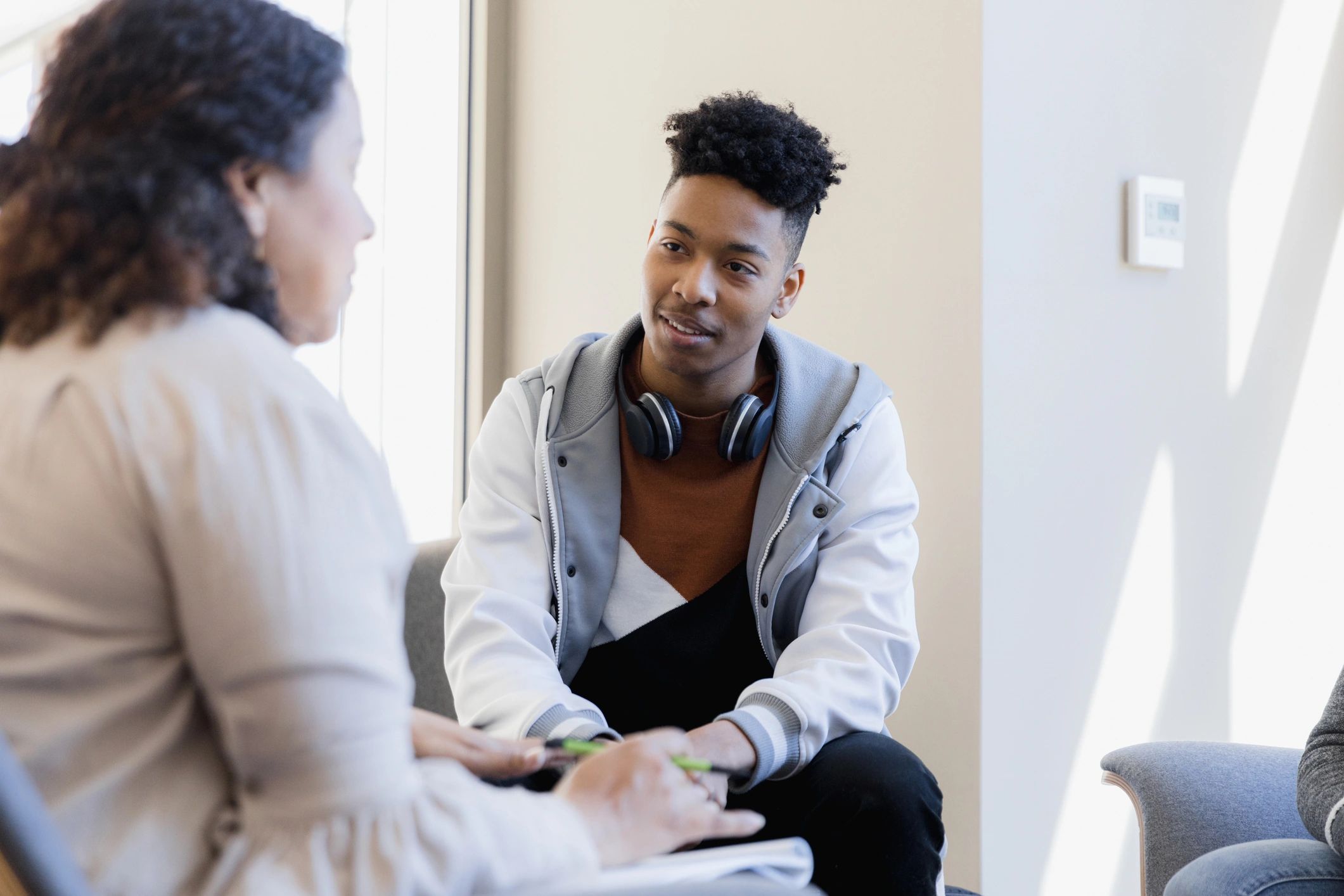 Counsellor speaking with a young person in a supportive setting