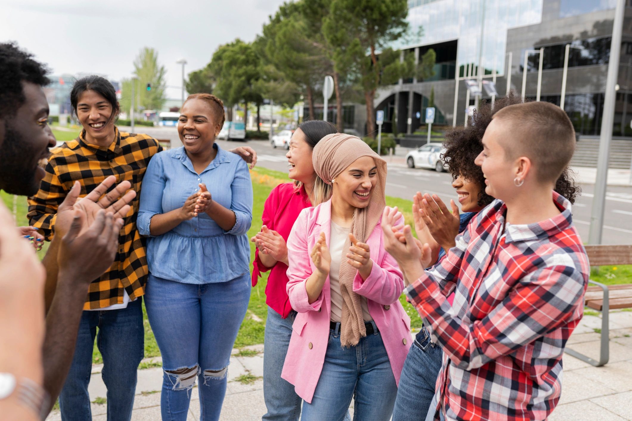 Multicultural friends spending time together outdoors, smiling and talking