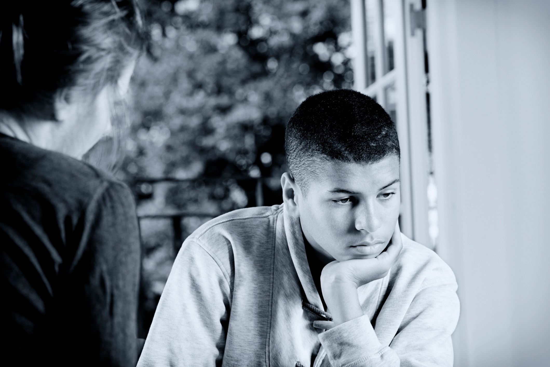 Counsellor speaking with a young person, representing confidential guidance