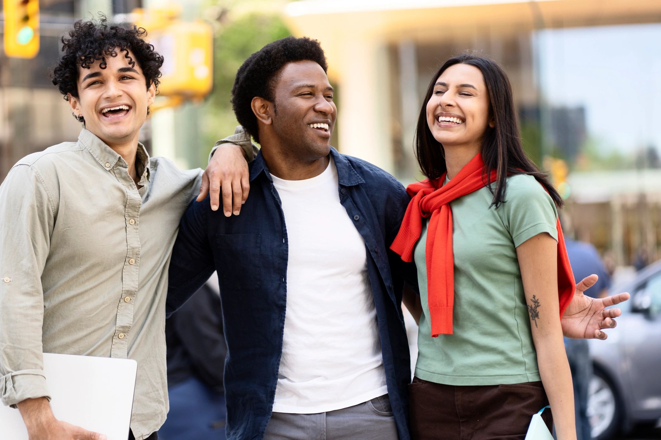 Smiling young adults walking together in a city, representing peer support