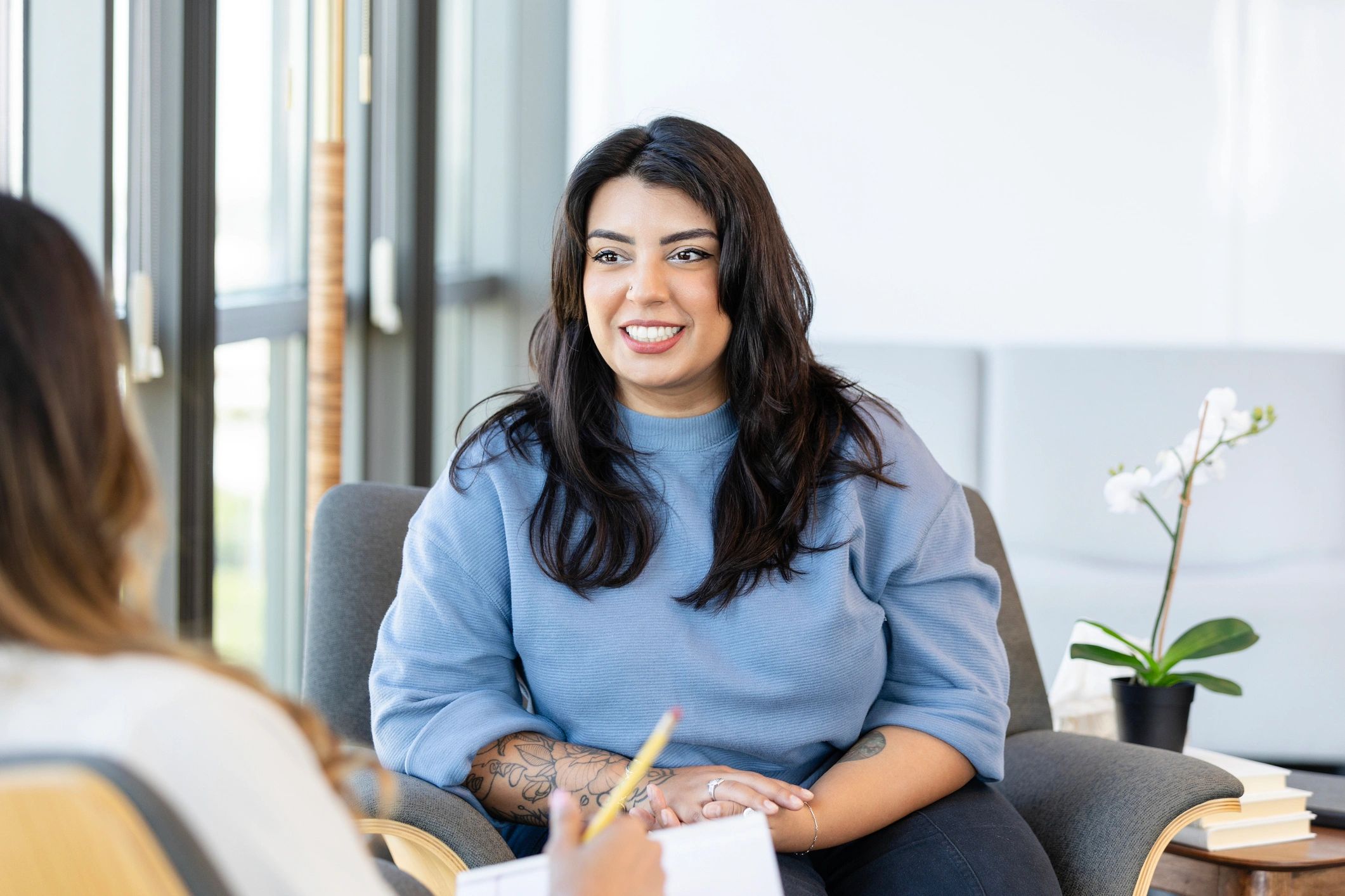 Supportive counseling conversation with note-taking counselor