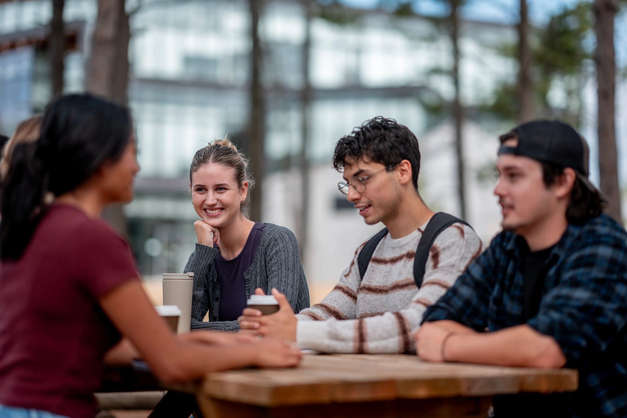 Friends talking together at an outdoor table